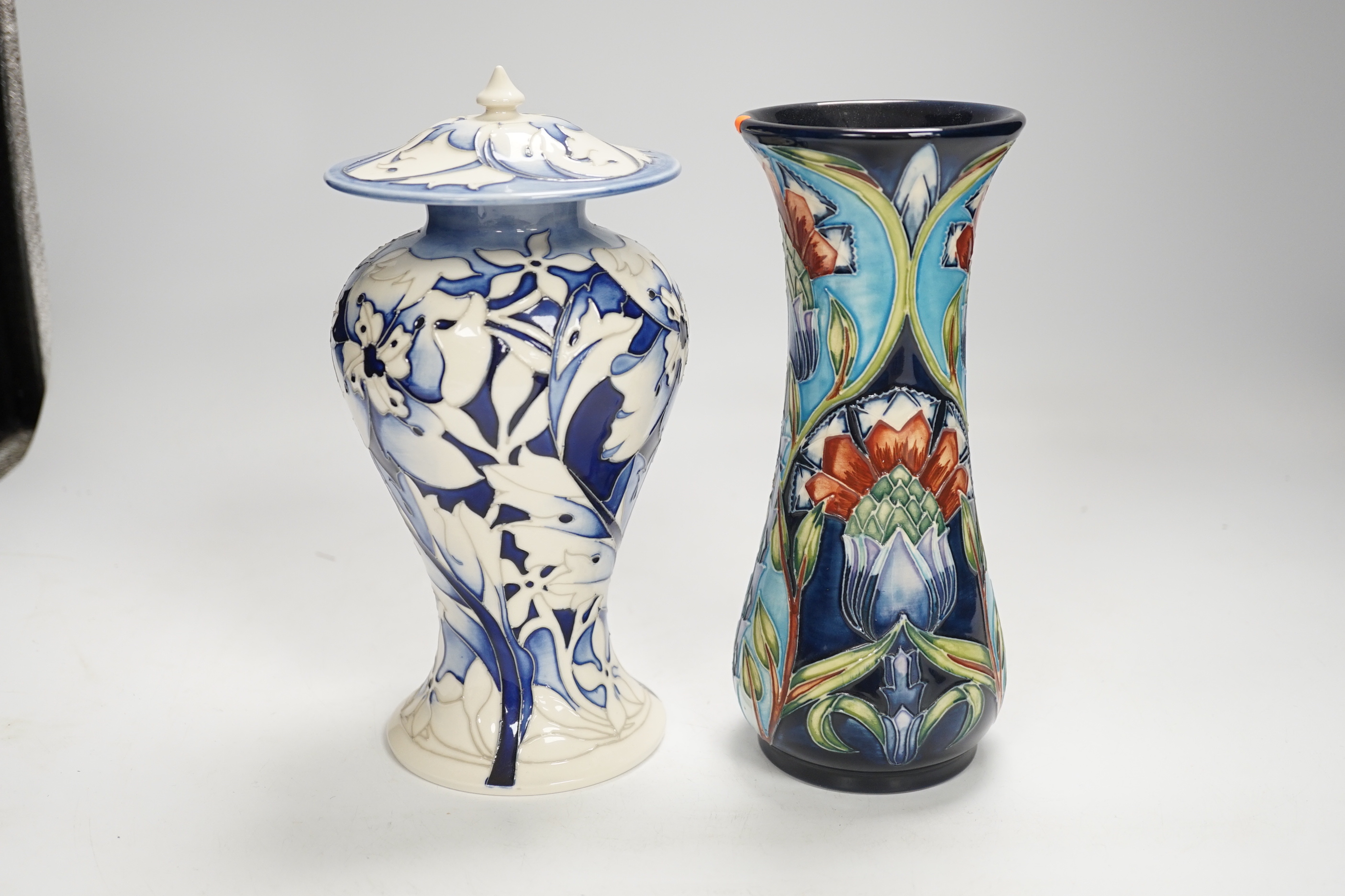 A Moorcroft floral vase designed by Shirley Hayes, limited edition 27/30 and a Moorcroft blue and white jar and cover by Emma Bossons, limited edition 2/3, largest 23cm high